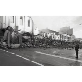 Police officer inspecting the aftermath of the Reid's (Cribb & Foote) fire, Bell Street, Ipswich, August 1985