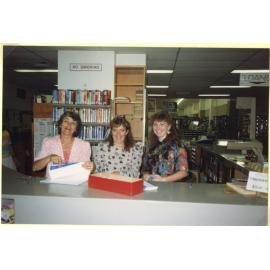 Staff standing behind the front counter, Ipswich Municipal Library, Ipswich Centre, Bell & East Streets, Ipswich, 1989