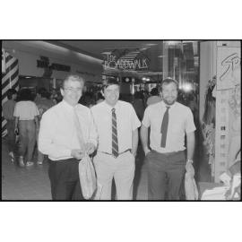 Three unidentified men outside Day & Grimes furniture store under The Boardwalk sign in Redbank Plaza Shopping Centre during the grand opening, Redbank, September 1985