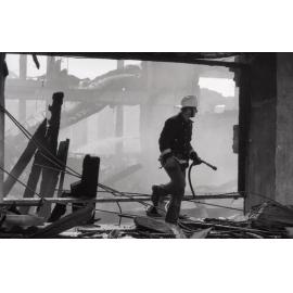 Firefighters walking though the remains of the Reid's store following the fire, Ipswich, August 1985