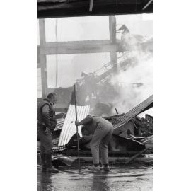 Police officers inspecting the aftermath of the Reid's (Cribb & Foote) fire, Bell Street, Ipswich, August 1985