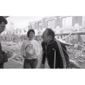 Man and woman being interviewed viewing the aftermath of the Reid's (Cribb & Foote) fire, Bell Street, Ipswich, August 1985