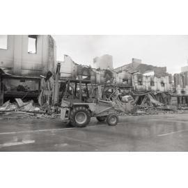 Bulldozer cleaning up the street of rubble, in the aftermath of the Reid's (Cribb & Foote) fire, Bell Street, Ipswich, August 1985