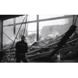 Firefighters hosing down the remains of the Reid's store following the fire, Ipswich, August 1985