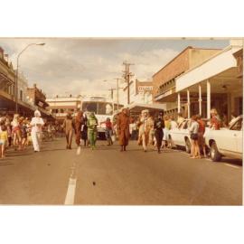 Library staff dressed as zoo animals with the Bookmobile in a parade, Brisbane Street, Ipswich, c.1980