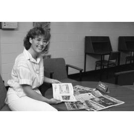 Unidentified library staff member with magazines at Redbank Plaza Library, Redbank, September 1985