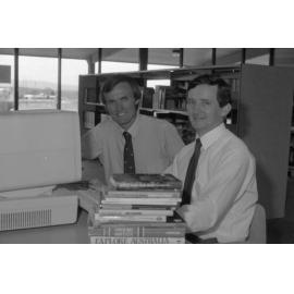 Moreton Shire Counsellor Neil William Russell and unidentified man using the computer at Redbank Plains Library, Redbank Plains, September 1985