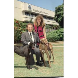 David Underwood, with unidentified lady and two greyhounds, in front of Council chambers, South Street, Ipswich, 1988