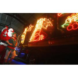 Santa, and his elf helper, with the decorated Sapar truck, Ipswich, December 2010
