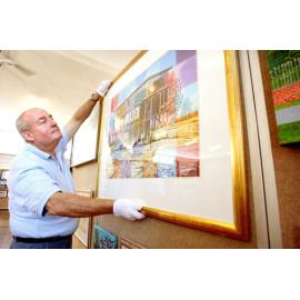 Wayne McDonnell hanging artworks for the Ipswich Art Awards, April 2007