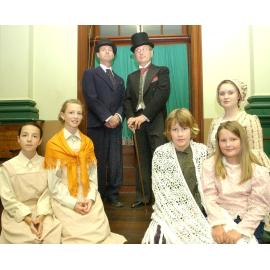 Otis Ogg as "Dr Grimwig", Bob Polowyj as "Mr Brownlow", and Ruby Farley, Jemma Farley, Danica Muller, Nardine Ledger, and Rebecca Noble as part of the cast in the Oliver Musical, Ipswich, August 2004 