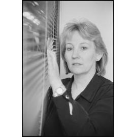 Unidentified woman looking through venetian blinds, location unknown, 5th August 1994