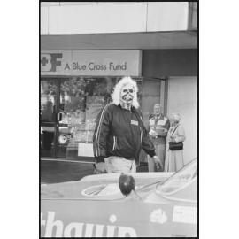 Unidentified man wearing a zombie facemask walks alongside Variety Bash entrants, Brisbane Street, Ipswich, 5th August 1994