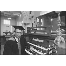 Unidentified organist in academic cap and gown, at St Paul's Anglican Church, Ipswich, August 1994
