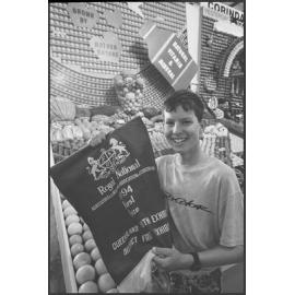Unidentified boy with First Prize banner in front of the Kalbar fruit display at the Ekka, Brisbane Showgrounds, Brisbane, 18th August 1994