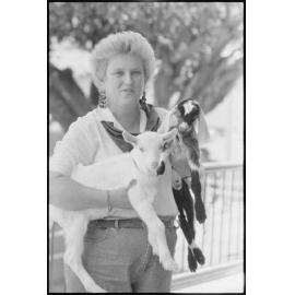 Unidentified woman with baby goats at the Ekka, Brisbane Showgrounds, Brisbane, 20th August 1994