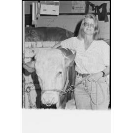 Unidentified woman with cow at the Ekka, Brisbane Showgrounds, Brisbane, 20th August 1994