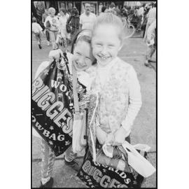 Two unidentified girls with show bags at the Ekka, Brisbane Showgrounds, Brisbane, 21st August 1994