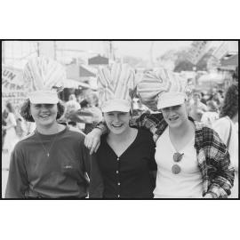Three unidentified young women wearing novelty hats at the Ekka, Brisbane Showgrounds, Brisbane, 21st August 1994