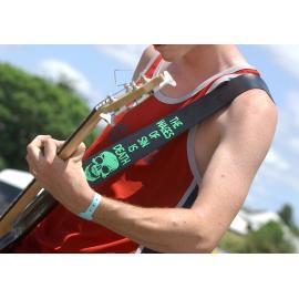 Not so subtle message on the guitar strap of the bass player from Christian rock band Soljah at Sonfest, Ipswich, 20th January 2005