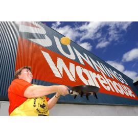 Bernee Smee flipping a pancake for the pancake fundraiser at Bunnings Warehouse, Ipswich, 31st January 2005