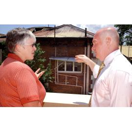 District manager Pam Lane shows the Minister of Health Gordon Nuttall, the destruction caused by the fire at the Ipswich hospital, Ipswich, 8th February 2005
