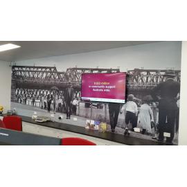 Whitehead Studio image of flood waters under the Bremer River Rail Bridge (1930s), used as a feature wall at the Bendigo Bank Booval branch, Ipswich, 2018