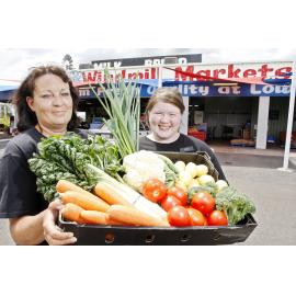 Employees of the Windmill Markets fruit shop on the Warrego Highway near Gatton, Trish Maycock and Lisa Beasley, preparing for the price increase to fruit and vegetables caused by the recent flood damage to Queensland crops, Ipswich, 4th January 2011