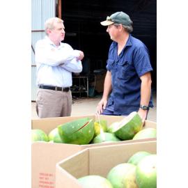 Federal minister for infrastructure Simon Crean speaking with fresh vegetable farmer Brian Crust where his watermelons have been been destroyed by flood water at Mt Sylvia, 5th January 2011