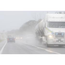 Cars and Trucks drive through wet weather along the Cunningham Highway at Amberley as the region experienced heavy rain again yesterday, Ipswich, 6th January 2011 