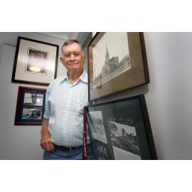 Noel Davis of Raceview beside photographs of buildings and structures built by his grandfather Walter Taylor, Ipswich, 21st January 2011 