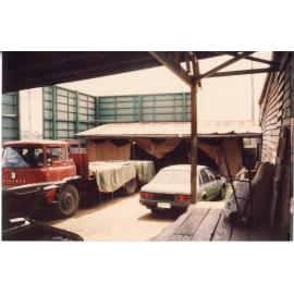 Car and Truck parked at Risson's Produce