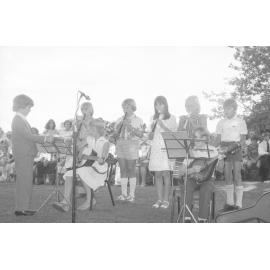 Unidentified children playing music at the the memorial in honour of Mary Aileen Bell, Coochin Coochin, Scenic Rim, April 1980