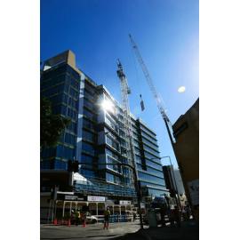 A large mobile crane dismantles the crane used to build Icon Ipswich marking the buildings completion, Ipswich, 25 May 2013