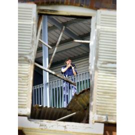 A police scenes of crime officer photographs the fire ravaged remains of the Ipswich Hospital's Old Education Centre, Ipswich, 7 February 2005 