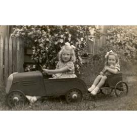 Horn children in a pedal car with trailer, at Bergin's Hill, Bundamba, Ipswich, 1940s