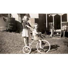 Horn children on a tricycle, Bergin's Hill, Bundamba, Ipswich, 1940s