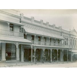 Men standing outside buildings on Brisbane Street, opposite School of Arts building, Ipswich, mid-1890s
