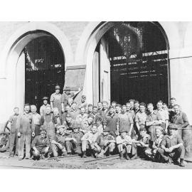 Group of men in front of Erecting shop at Ipswich Railway Workshops, North Ipswich, 1950