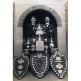 Will Jones, secretary and A. Wade, conductor, with trophies of the Ipswich City Vice-Regal Band, Ipswich, 1919