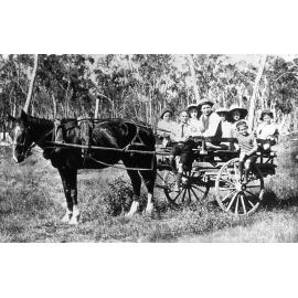 Group of people in a cart, Ipswich, early 1900s