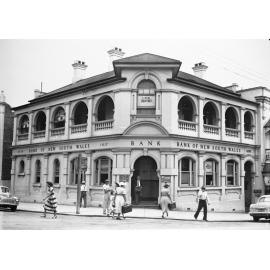 Pedestrians in front of Bank of New South Wales, corner Bell and Brisbane Streets, Ipswich, c.1950