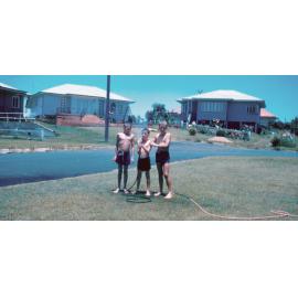 Playing with the hose, Ipswich, 1961