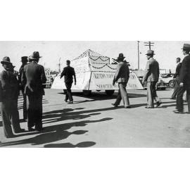 Men marching with float 'Agitation and Closer Organisation for a shorter working week.'  Ipswich, 1940