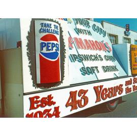 Display on side of McMahons Soft Drinks' truck during parade in Ipswich, 1977