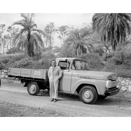 Ford utility truck, with who is believed to be H. (Mick) Thorne, building contractor, in front of ute, Ipswich, 1960