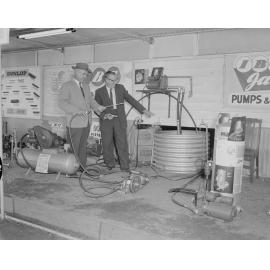 Product demonstration by staff at Mining and Hardware Supplies exterior display, Ipswich Show, Ipswich, 1961