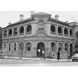 Pedestrians in front of Bank of New South Wales, corner Bell and Brisbane Streets, Ipswich, c.1950